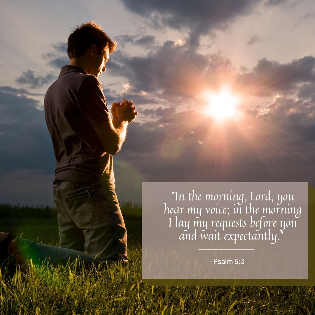 A man praying outdoors at sunrise, kneeling in a field with a dramatic sky in the background, accompanied by good morning prayer messages on the image.