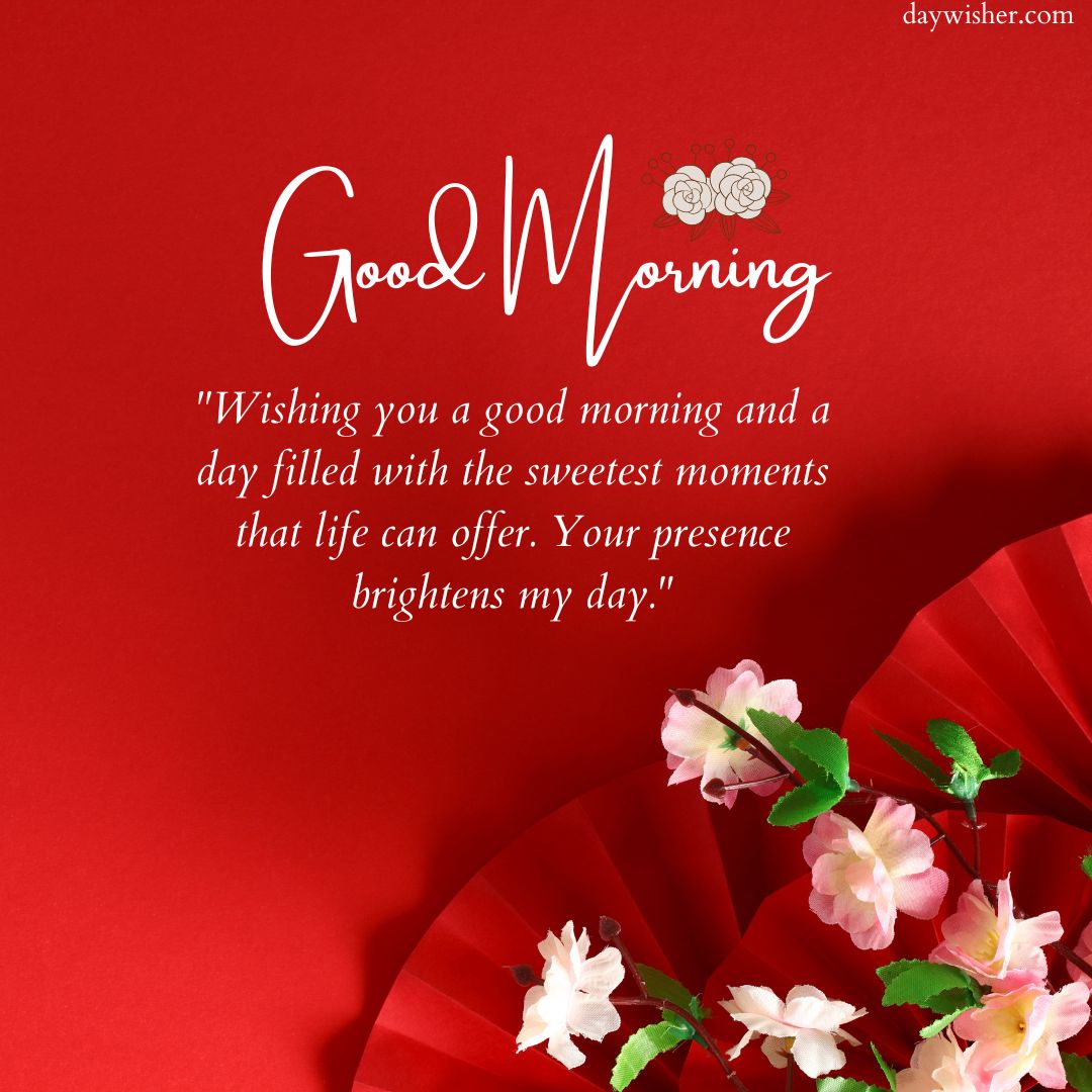 A vibrant red background featuring a "good morning" greeting with an inspirational quote, decorated with pink cherry blossoms and a subtle image of two coffee cups in the upper left corner.