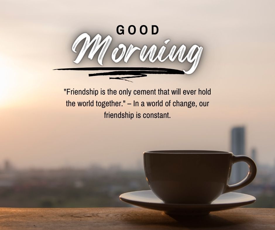 A serene morning scene featuring a coffee cup on a table with a blurry cityscape background at sunrise, overlaid with a "Good Morning" greeting and a friendship quote.