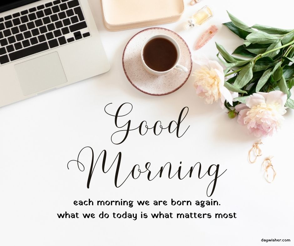 A neatly arranged desk with a laptop, a cup of coffee, and flowers around an inspirational quote saying "good morning" in elegant script, perfect for good morning images.