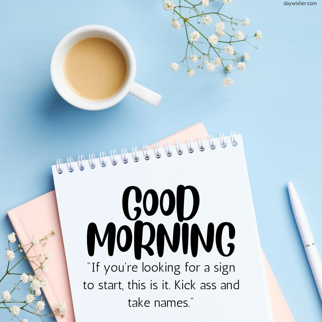 A motivational morning setup with a notepad reading "Good Morning Images with Quotes" and an inspiring quote, a cup of coffee, and small white flowers on a blue background.