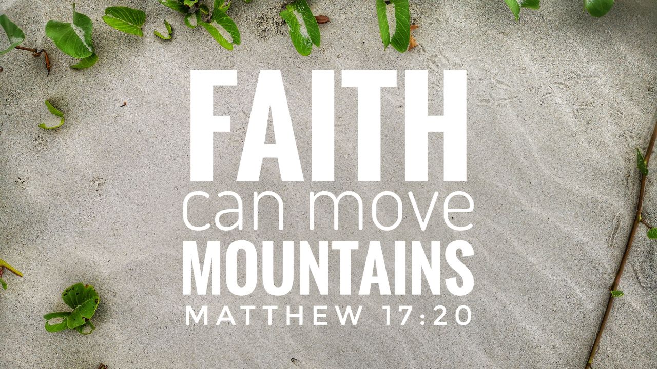 Inspirational Bible verse "faith can move mountains - Matthew 17:20" displayed in bold white letters over a sandy background with small green leaves scattered around.
