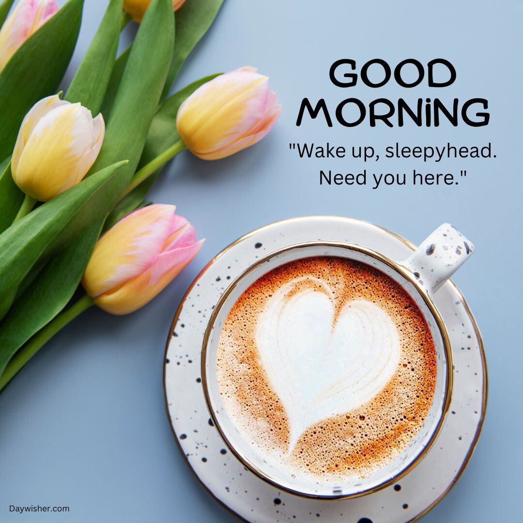 A morning greeting image featuring a cup of coffee with a heart-shaped design in its foam, accompanied by a bouquet of pink and yellow tulips. The text "Good Morning Love" and an affectionate