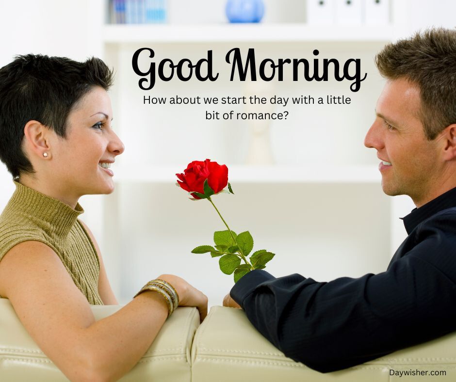 A man and a woman smiling at each other, seated on a white sofa. The woman with short dark hair receives a red rose from the man. Text overlay says "Good Morning Love. How about