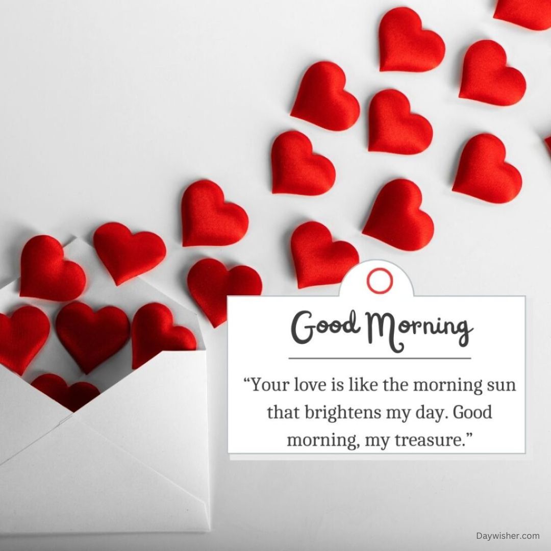 A white surface scattered with red hearts and an open envelope, next to a card reading "Good Morning Love" with a romantic quote. The composition conveys warmth and love.