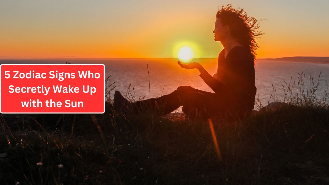 A woman meditating by the sea, sitting cross-legged, holding the sunrise in alignment with her hands. The sky is illuminated with orange hues. Text overlay: "5 Zodiac Signs who secretly wake up