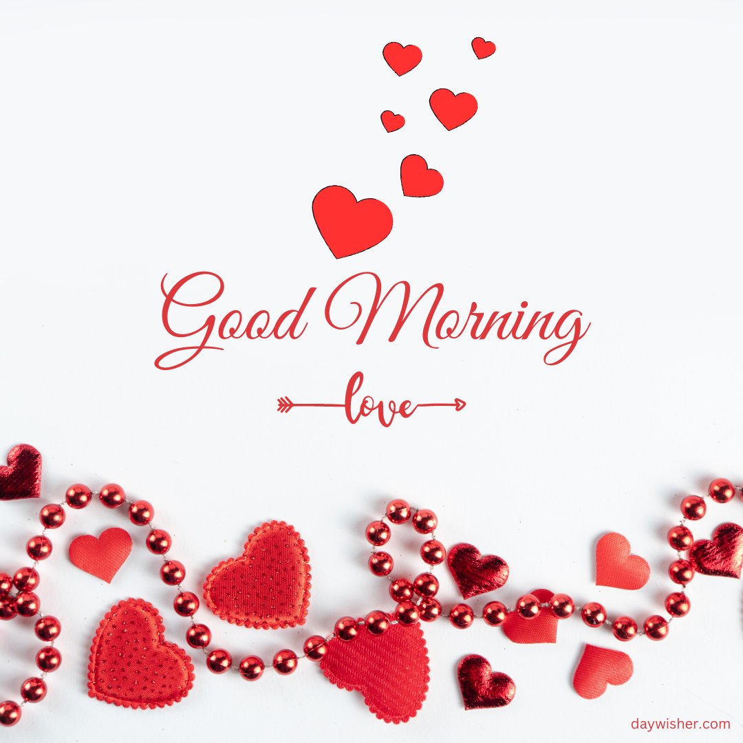 Good morning heart image featuring a string of red hearts and beads on a white background. The text "Good Morning" is elegantly displayed with a small arrow and the word "love" underneath. Several red hearts are scattered above the greeting, adding a touch of romance and warmth to this beautiful morning wish. Perfect for sharing affectionate good morning messages.