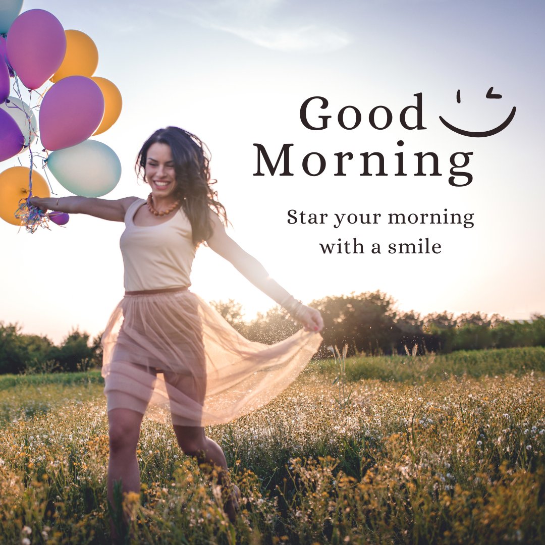 A joyful good morning image featuring a woman in a light dress running through a field, holding colorful balloons with a big smile on her face. The background is a beautiful sunrise, casting a warm glow over the scene. The text "Good Morning" is written in a cheerful font with a smiley face illustration and the message "Start your morning with a smile." This image captures the happiness and freshness of a new day, perfect for a bright and uplifting morning greeting.
