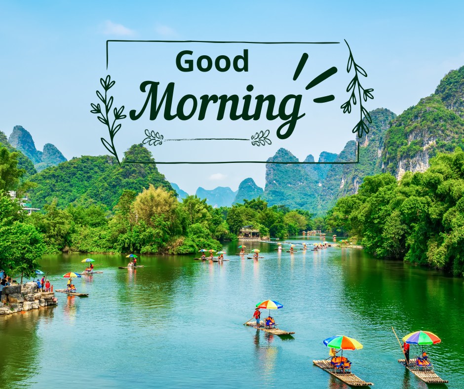 A captivating good morning image showcasing a serene river surrounded by lush green hills and limestone karsts. Colorful umbrellas on small boats dot the river, creating a vibrant scene. The text "Good Morning" is elegantly framed with decorative leaves. This image captures the tranquility and beauty of nature, making it perfect for a refreshing and scenic morning greeting.