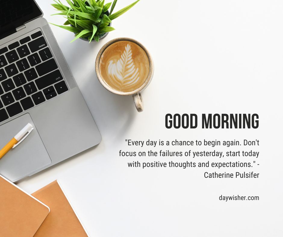A neatly arranged desk featuring a laptop, a cup of coffee with latte art, a notepad, and a pen. There's a motivational quote about positivity by Catherine Pulsifer in the 